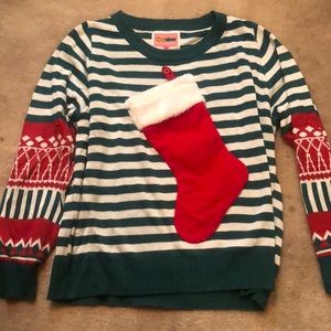 Tacky Christmas sweater that holds wine bottle